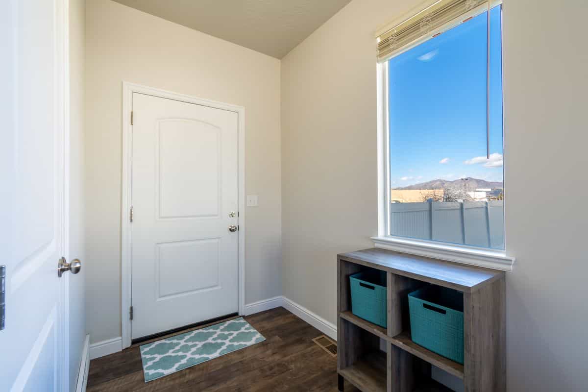 Entryway shelf illustrating the difference between a hook mirror and a mirror with shelf and hooks Contemporary entryway with a shelf and natural light, comparing mirror with hooks to mirror with shelf and hooks