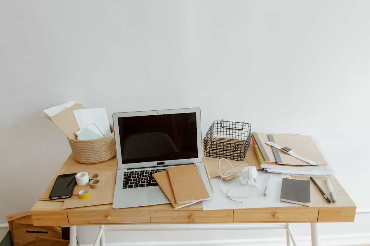Clean, organized desk with a laptop and notebooks, illustrating feng shui energy flow in an office