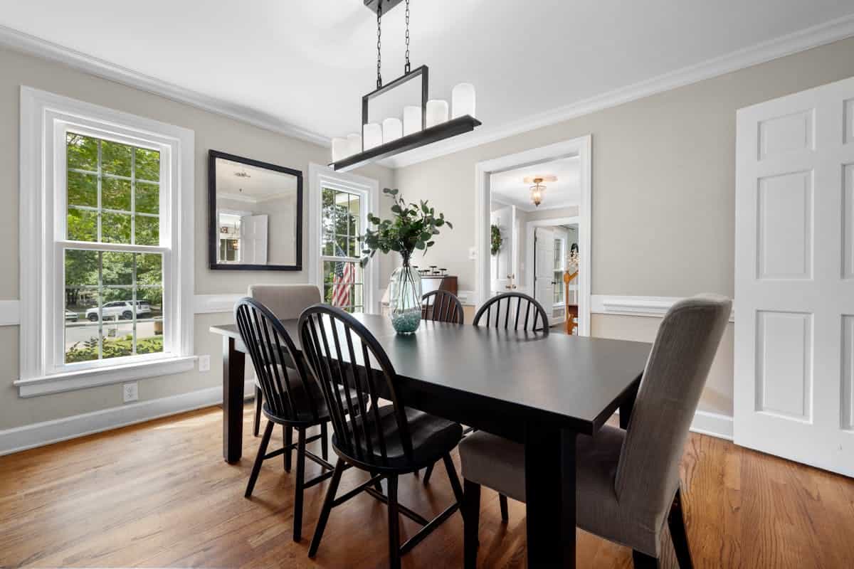 Modern dining room with a dark table showing mirror shape and orientation choices