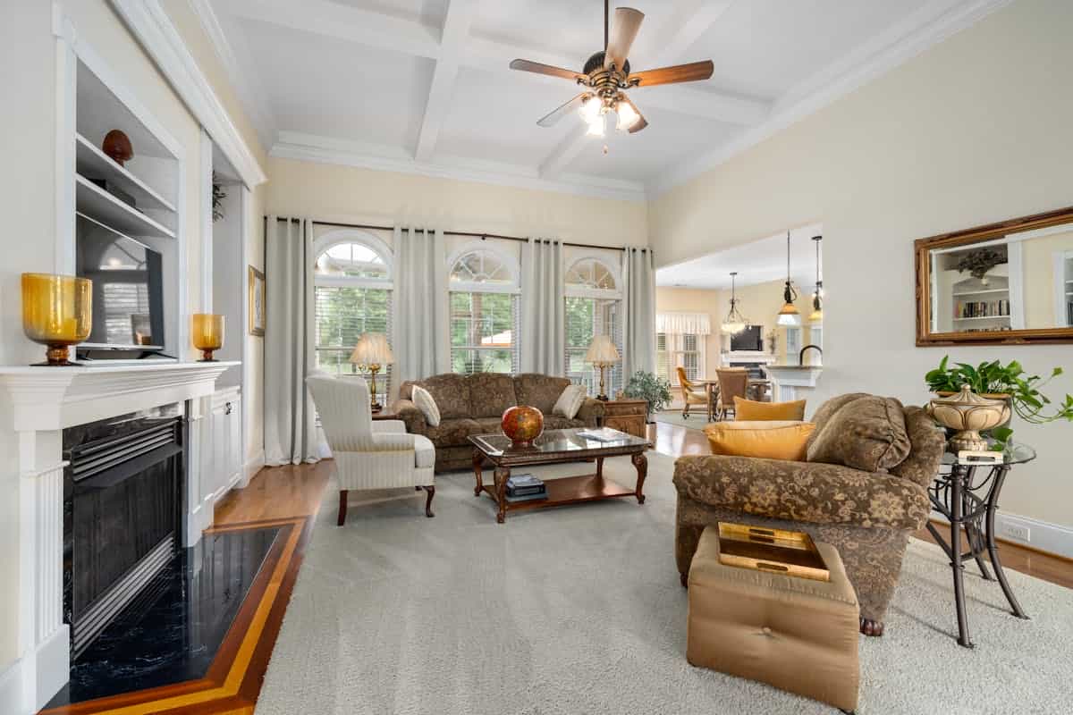 Spacious living room with a fireplace and elegant furnishings, illustrating where to place a large mirror