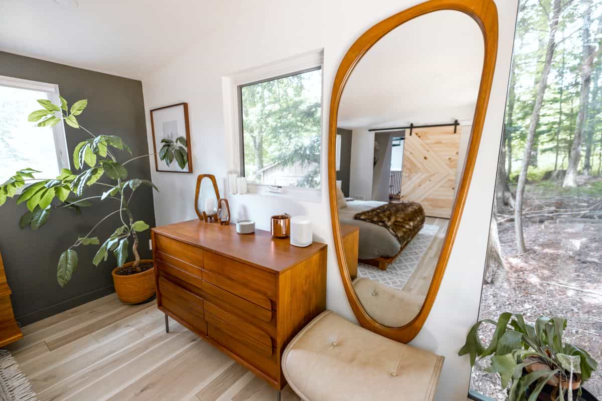 Wooden bedroom dresser with a large mirror and decor, illustrating a dresser with mirror for the bedroom.