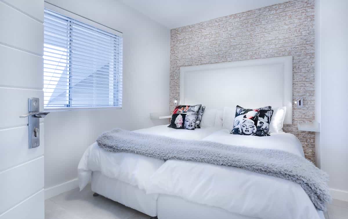 Serene bedroom illustrating feng shui bed direction as a separate question from placement Serene bedroom with neutral bedding, illustrating that feng shui bed direction is a separate question from bed placement