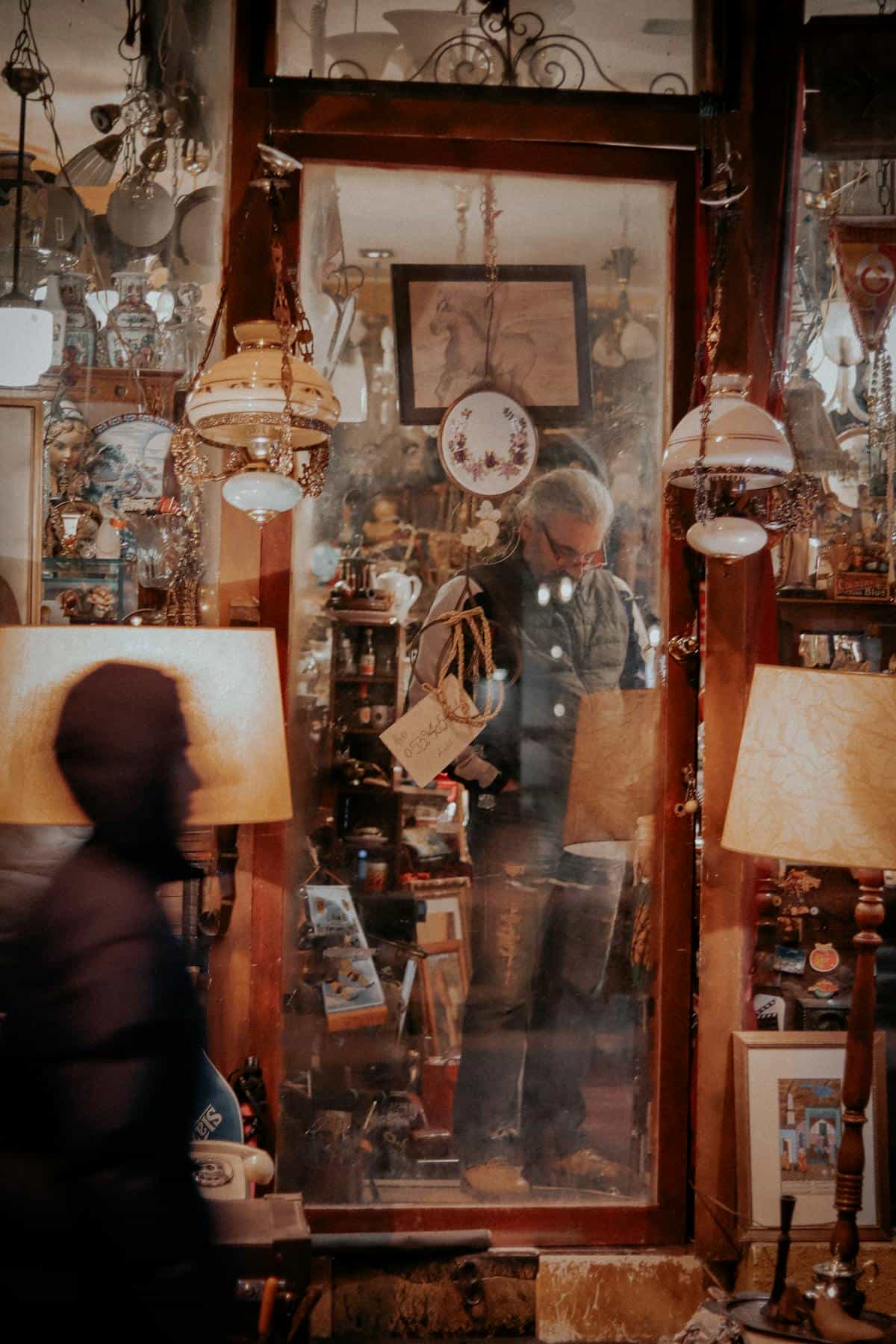 Dim atmospheric antique shop interior with vintage items and soft shadows