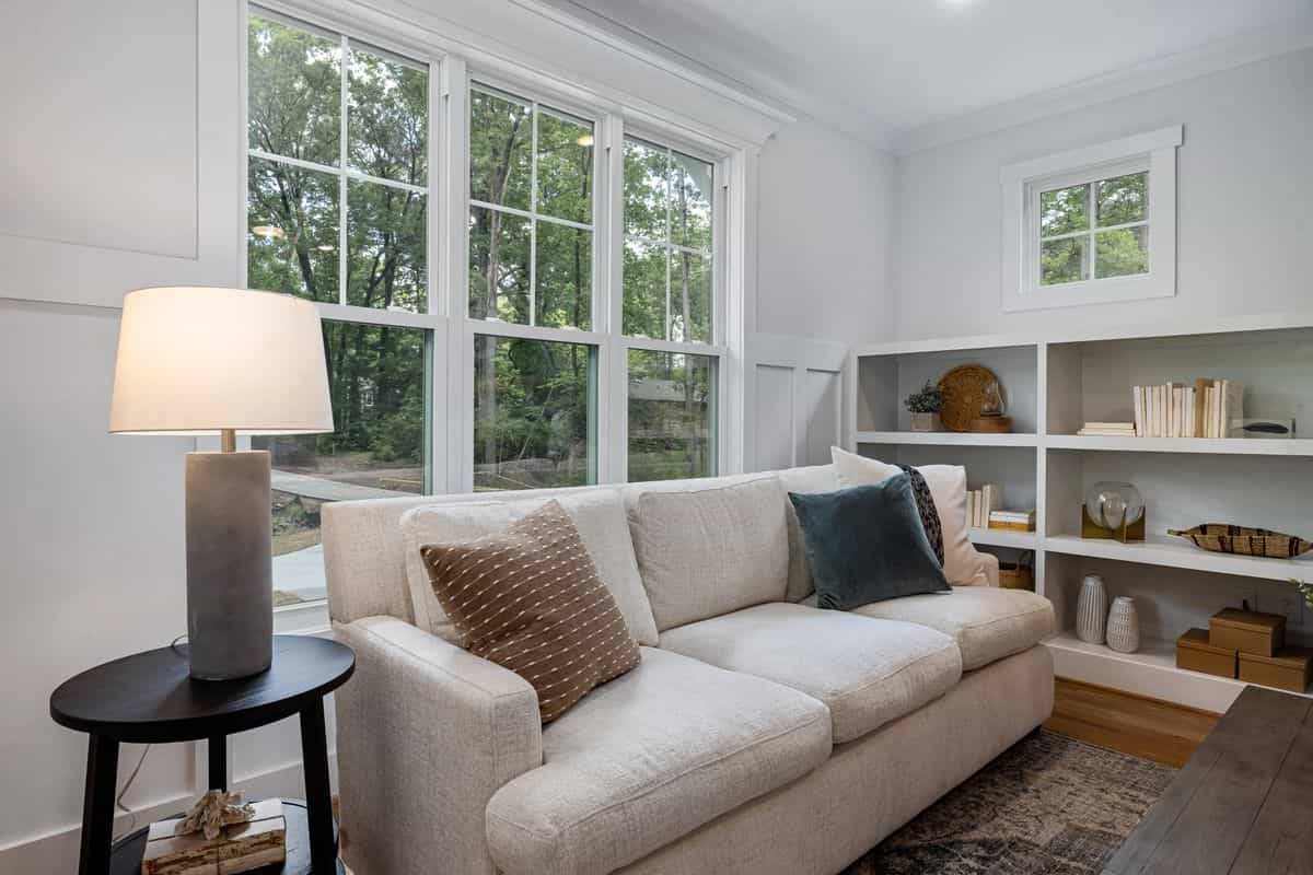 Sofa with a clear view of the room illustrating the feng shui command position for a couch Cozy living room sofa near large windows with a clear view of the room, illustrating the feng shui command position