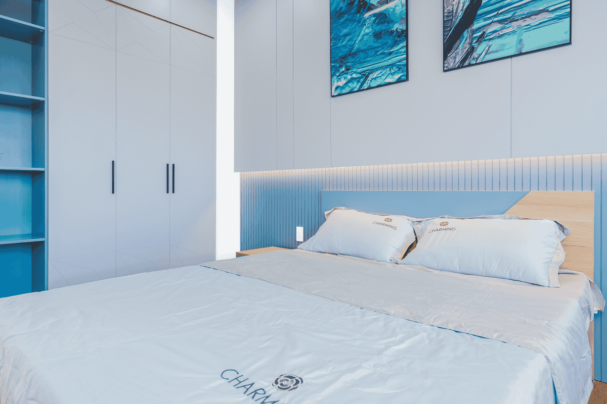 Bedroom with soft blue accents illustrating the calming Water element in feng shui bedroom colors Elegant bedroom with soft blue accents and a cozy bed, illustrating the calming feng shui Water element