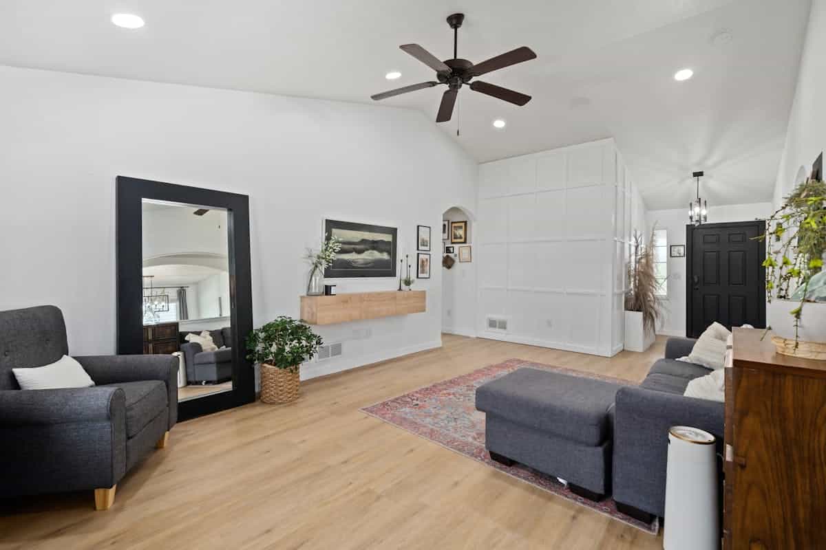 Stylish living room illustrating where to place a mirrored accent wall Spacious stylish living room with elegant furniture and lighting, illustrating where to place a mirrored accent wall