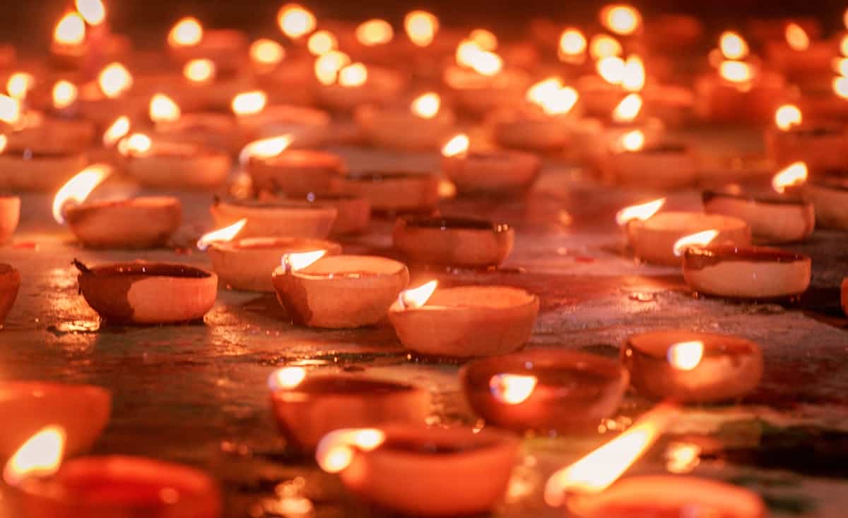 Traditional clay diya oil lamps glowing warm during Diwali festival night symbolising renewal light