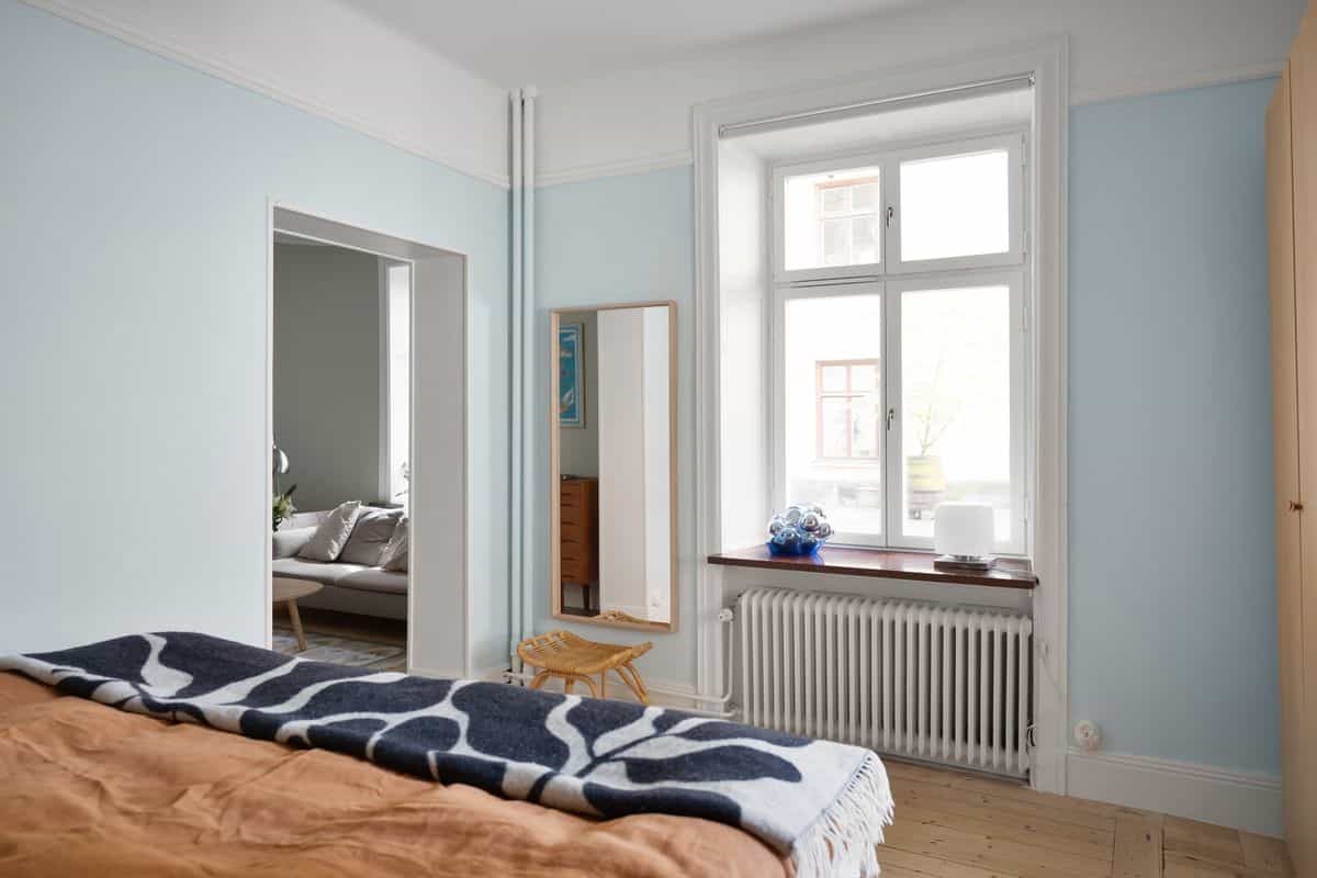 Tranquil bedroom with soft pastel decor and natural light, illustrating calming feng shui bedroom colors.
