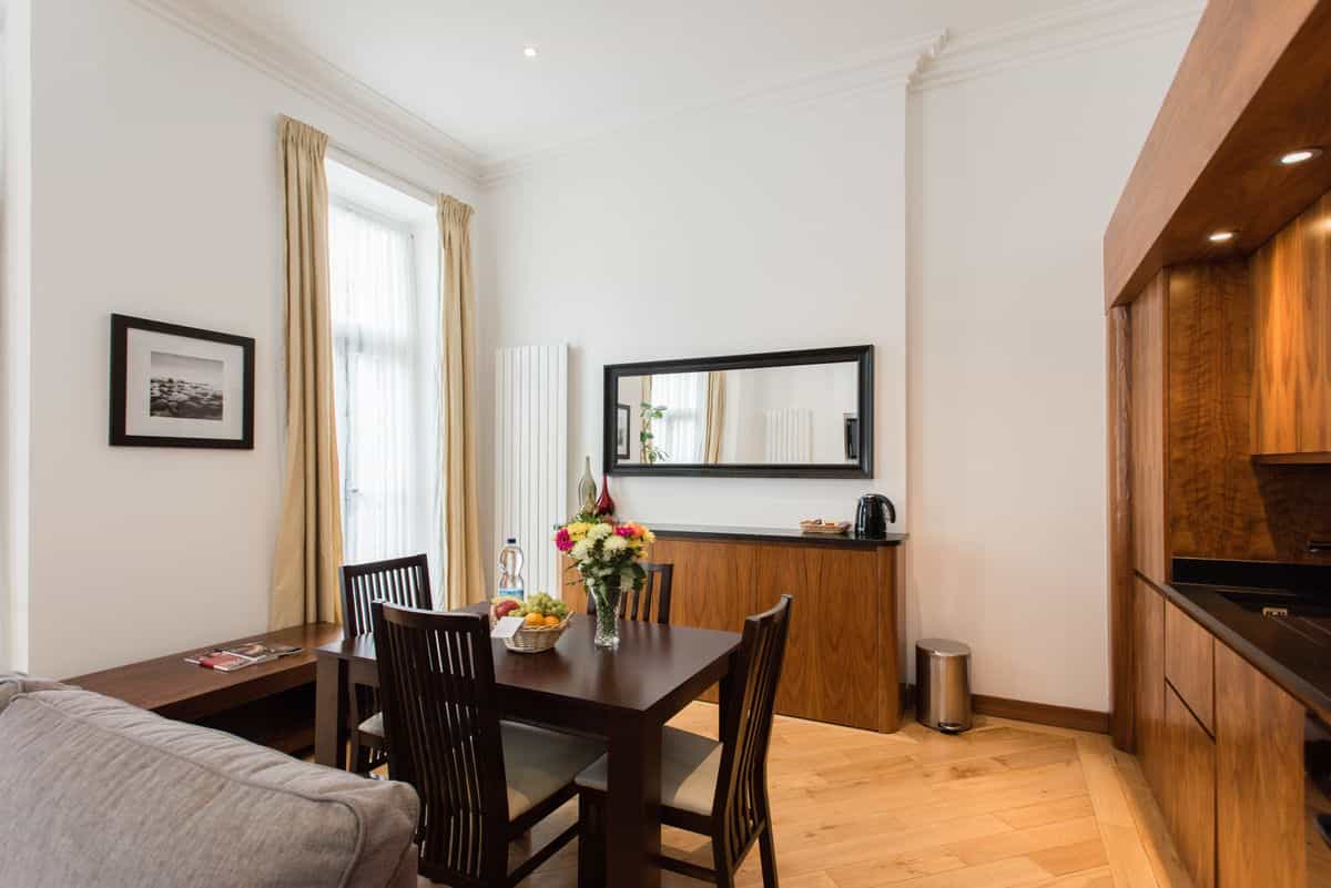 Modern dining room with wood furniture where a large mirror must be hung securely