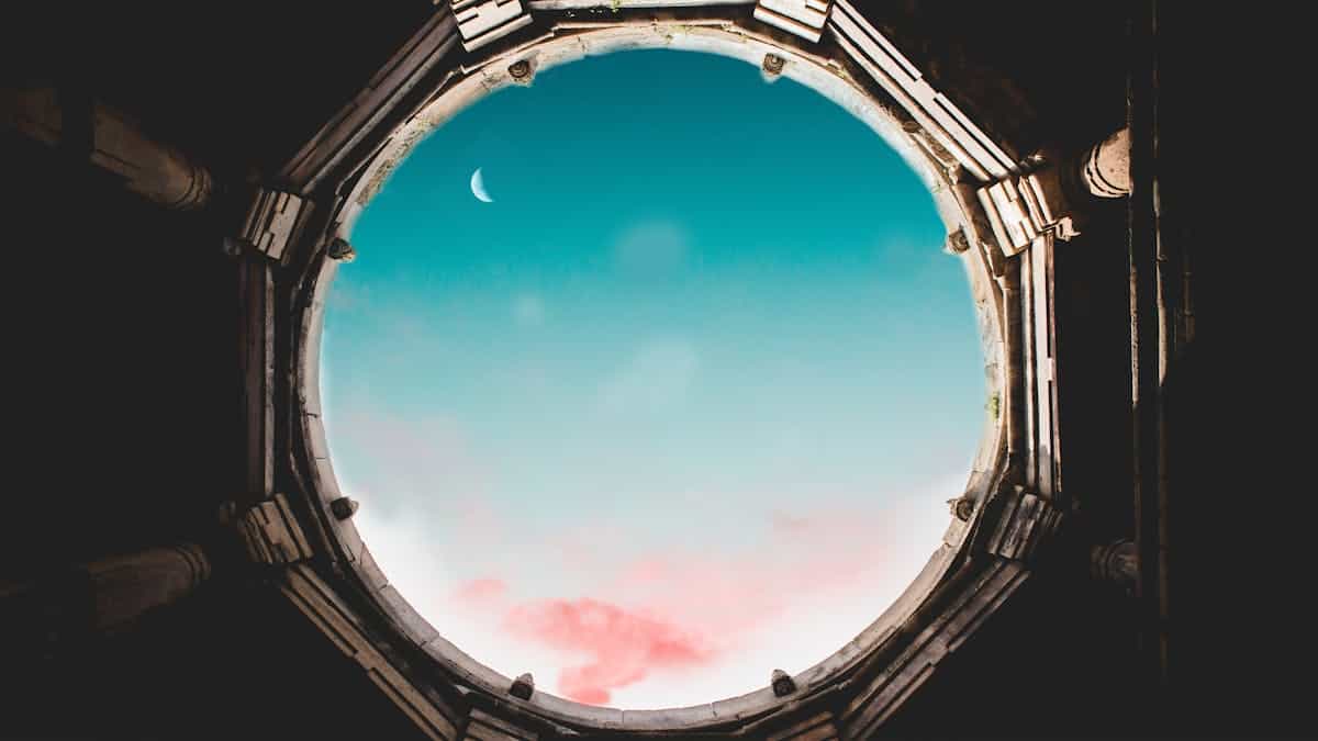 Moonlit window view with sheer curtains and soft blue night ambiance indoors