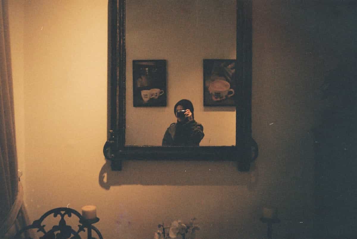 Vintage handheld mirror portrait composition echoing antique portal narratives and feminine reflective folklore