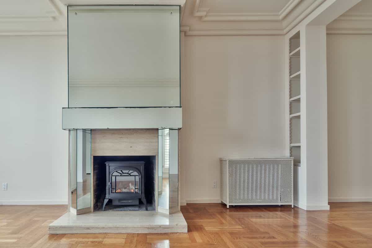 Modern living room with a mirrored fireplace as a focal point, illustrating a mirror over the mantel