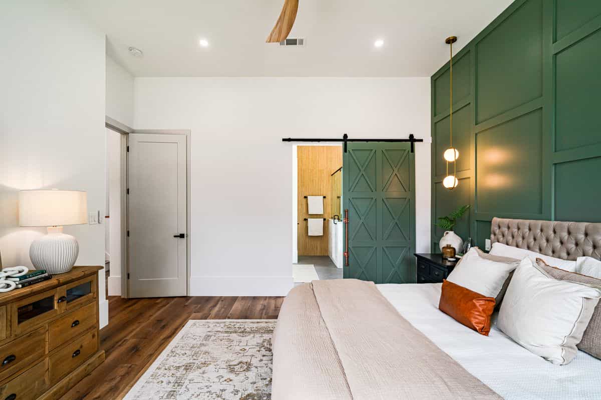 Bedroom with a green accent wall illustrating accent wall bedroom decor ideas Modern bedroom with a green accent wall, illustrating an accent wall as bedroom wall decor