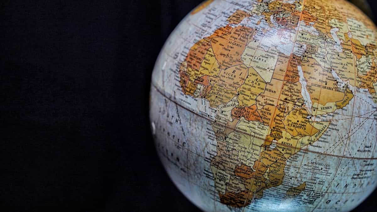 Close-up of a vintage globe highlighting Africa and the Middle East with intricate geography, representing the global diversity of mirror superstitions and cultural beliefs worldwide