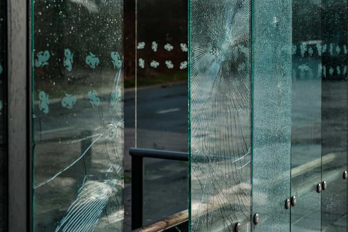 Vintage cracked mirror surface with dramatic shadows suggesting spiritual unease and symbolic weight after accidental breakage