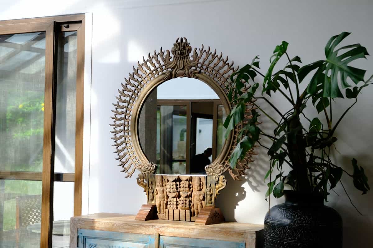 Ornate decorative mirror with intricate design and indoor greenery in a Nandi Hills setting suggesting Vastu-aligned placement in an Indian home