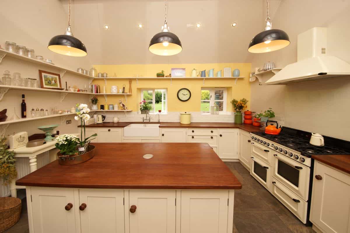 Farmhouse kitchen illustrating how to match metal wall art to your kitchen style Charming farmhouse kitchen with open shelving and vintage decor, illustrating matching metal wall art to kitchen style