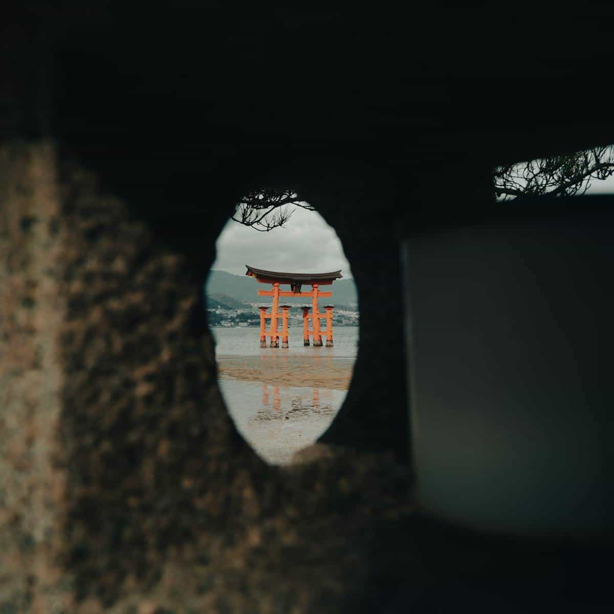 Shrine gate evoking Japan and sacred threshold Torii and open sky suggesting the Shinto threshold where mirrors house kami and moral reflection