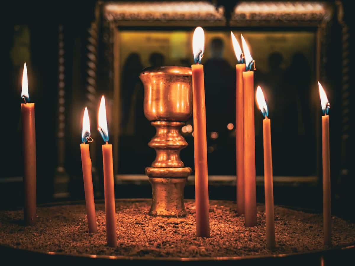 Peaceful candlelight setting in a Greek Orthodox church, capturing the spiritual atmosphere