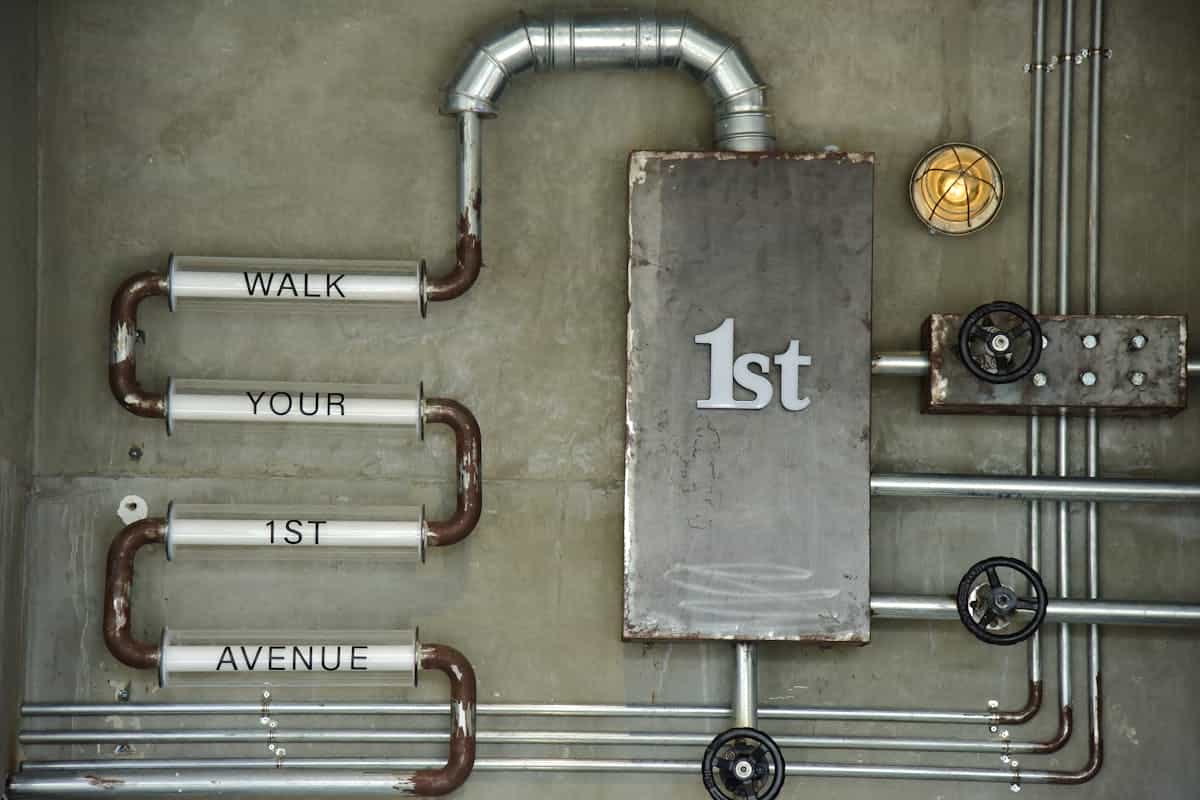 Industrial metal wall art illustrating durable finishes for kitchen metal wall art Industrial-style metal wall art on a concrete wall, illustrating metal wall art finishes for a kitchen