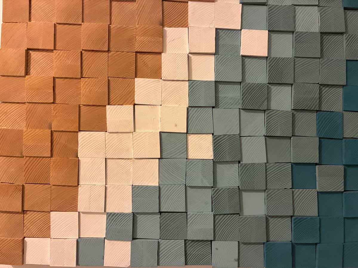 Geometric wooden block mosaic in earth tones, illustrating geometric and 3D wooden wall decorations