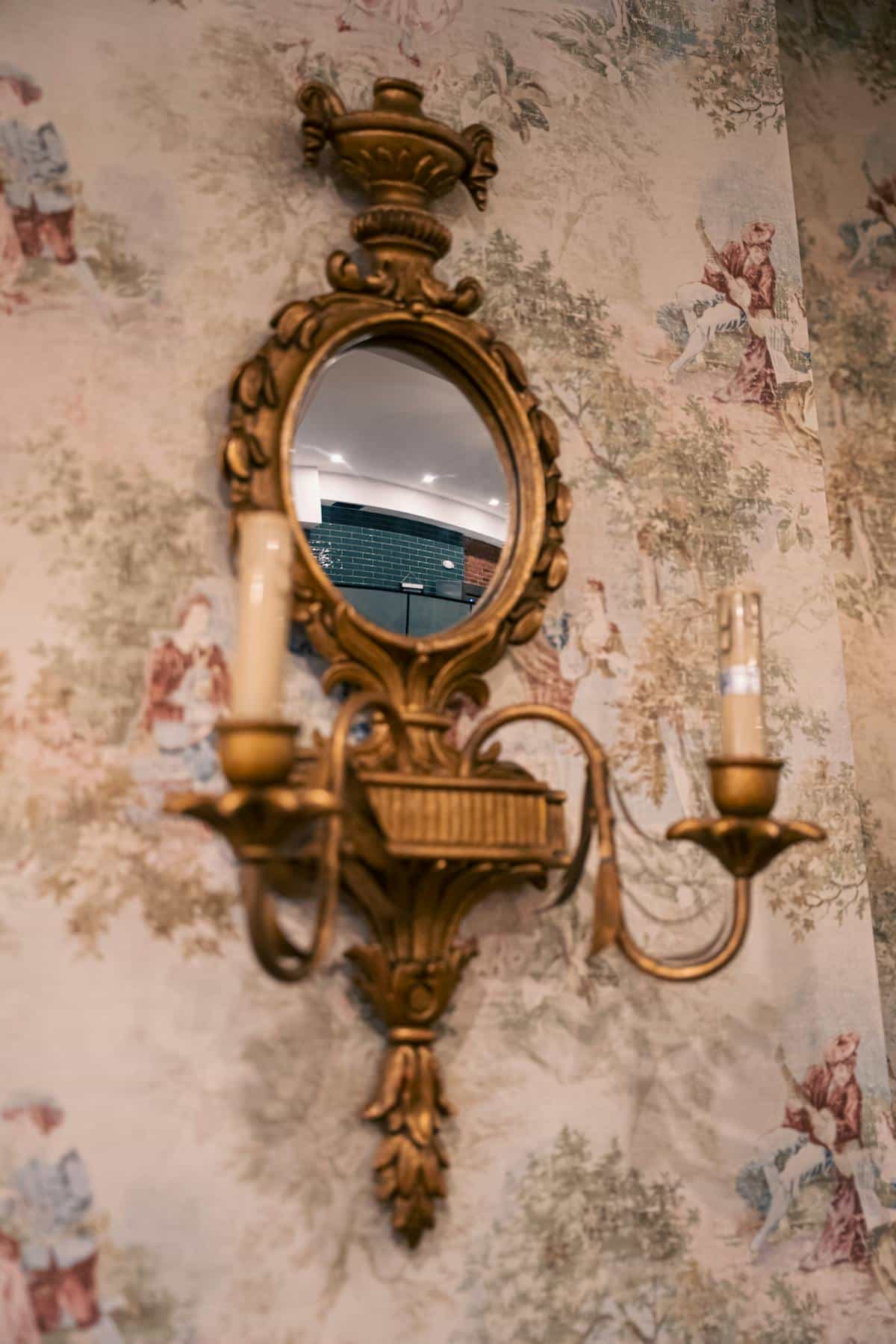 Person gazing at own reflection with contemplative posture in subdued lighting