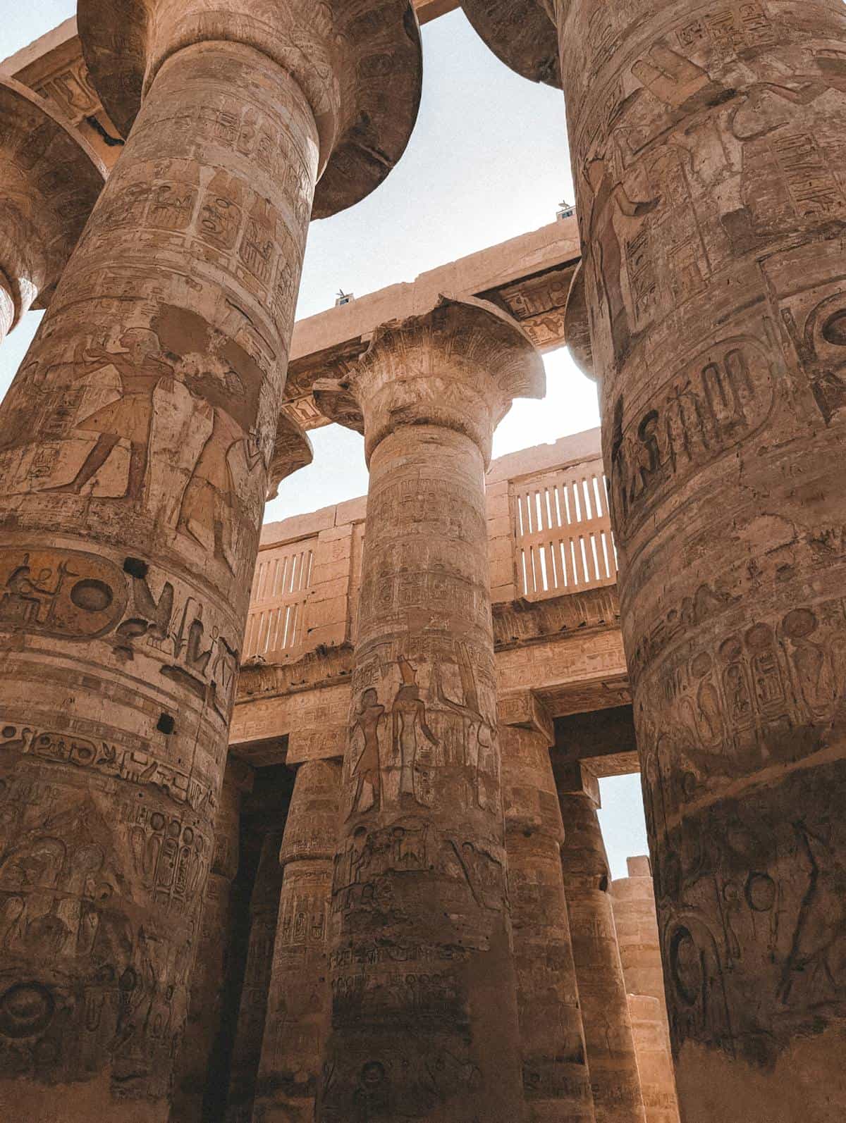 Karnak Temple colonnade representing the sacred architectural context of Egyptian mirror use and Ka theology Grand stone colonnade at Karnak Temple evoking the sacred Egyptian architecture where bronze mirrors served as ritual objects and Ka symbols