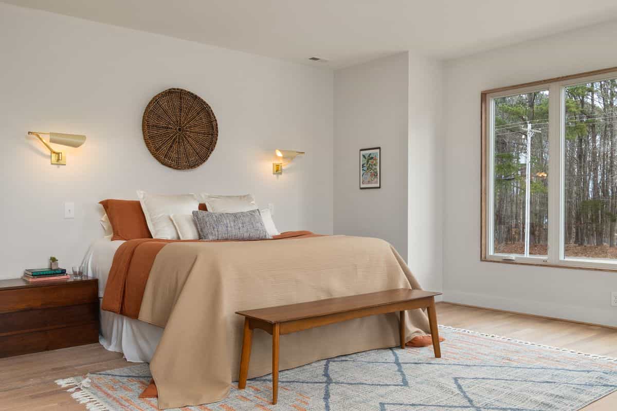 Bedroom with wooden furniture and clear floor space by large windows, illustrating feng shui clearance and pathways