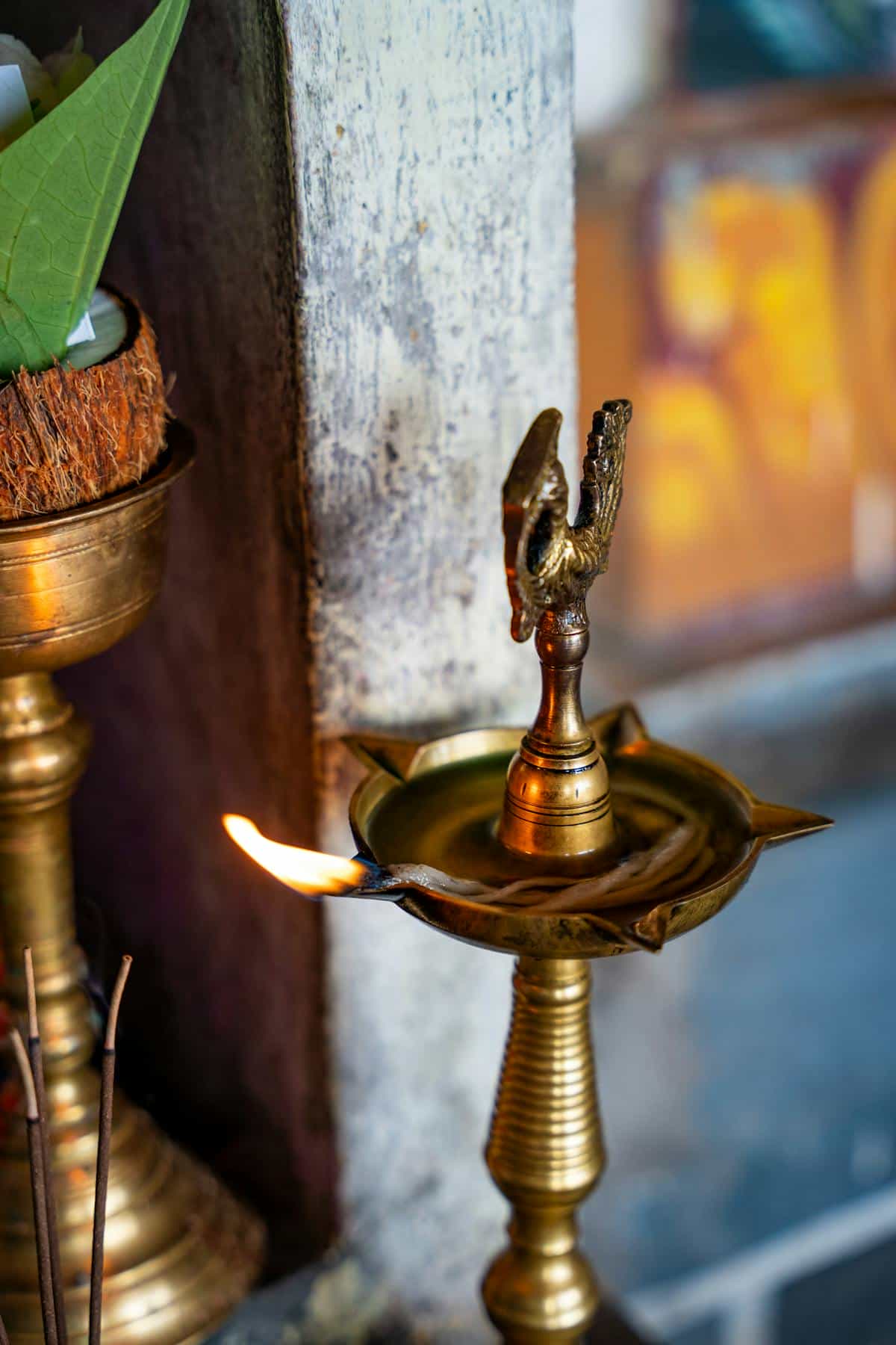 Lit brass oil lamp in a Sri Lankan temple showcasing Hindu ritual tradition evoking the sacred atmosphere of Darpana and puja