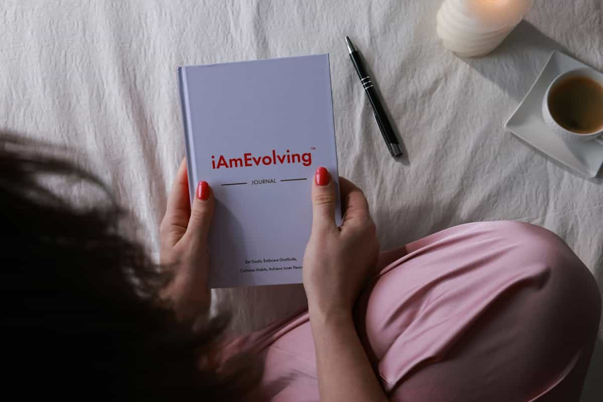 Morning journaling with candle and coffee suggesting the reflective daily practice that helps recurring mirror dreams resolve A serene morning routine with a journal, lit candle, and coffee evoking the reflective practice that helps process what recurring mirror dreams are pointing to