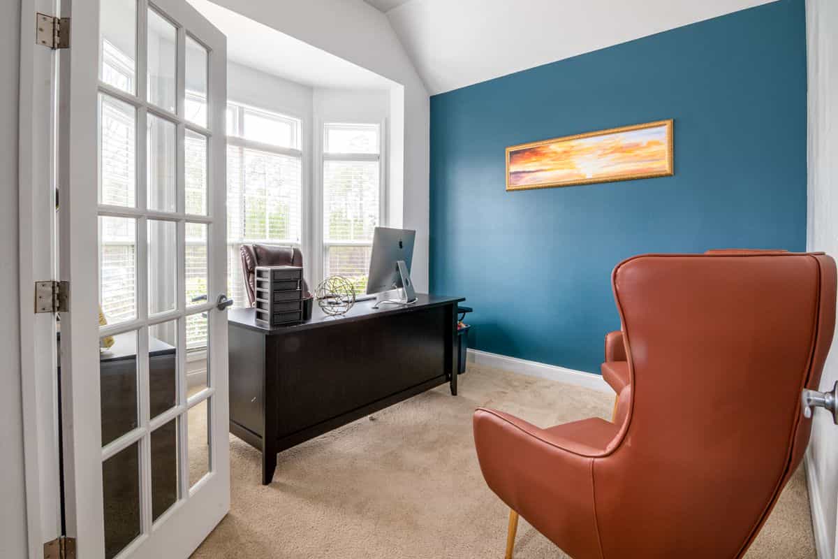 Dedicated home office room illustrating where to set up a feng shui home office Bright dedicated home office room with a desk, chair and natural light, illustrating a feng shui home office space