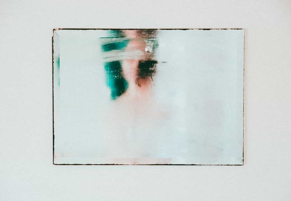 Abstract moody reflection on a fogged mirror representing an obscured or neutralized surface