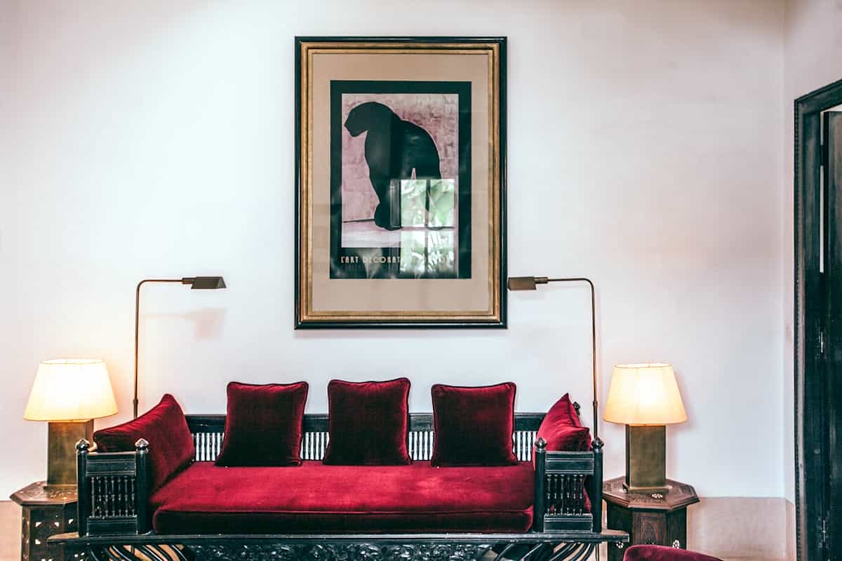 Sofa between two matching lamps illustrating feng shui balance and symmetry Sofa flanked by a pair of matching lamps in a bright living room, illustrating feng shui balance and symmetry