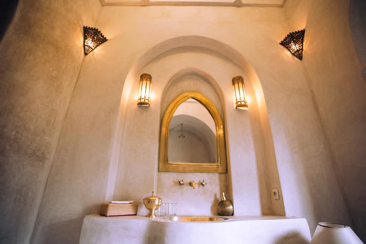 Interior featuring an arched mirror with soft lighting, illustrating arched full length mirrors