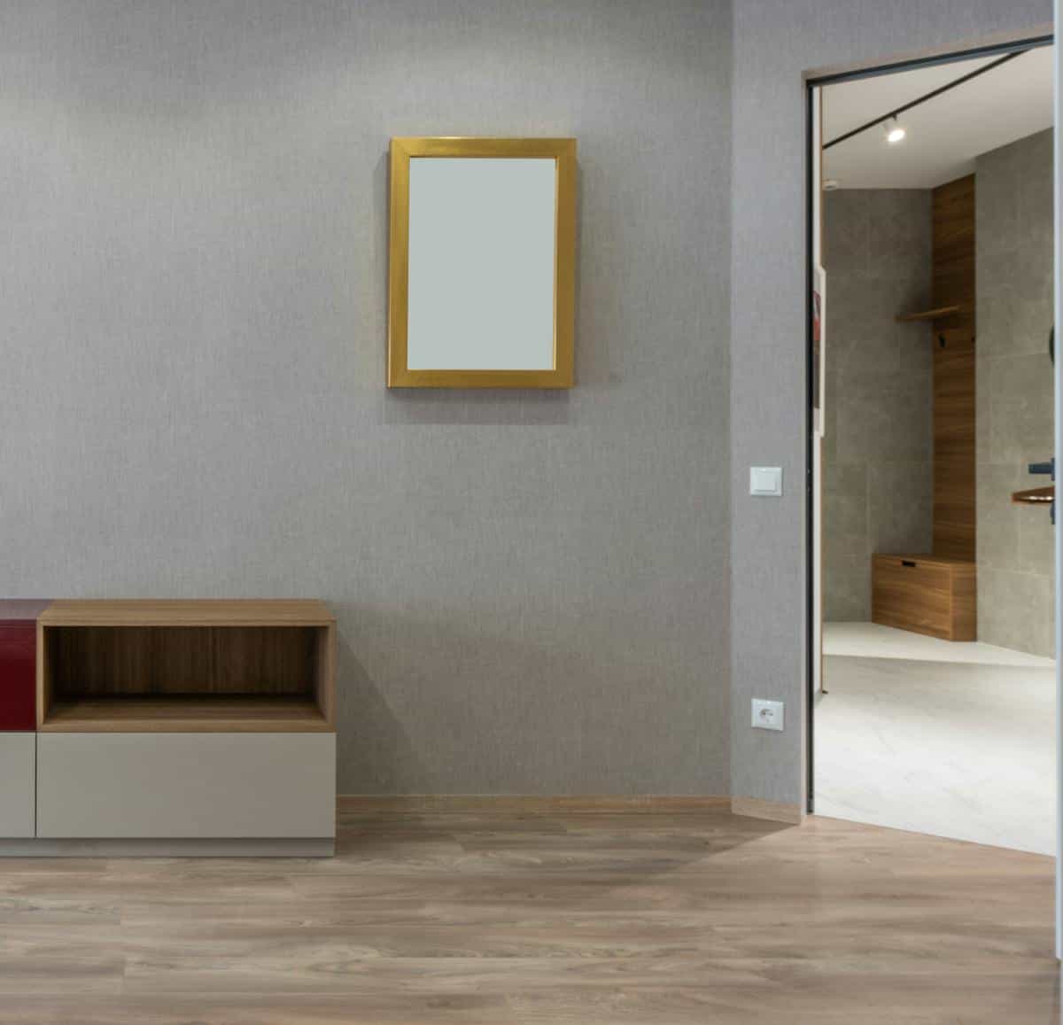 Contemporary room with a rectangular frameless full length mirror on a gray wall, illustrating frameless full length mirrors