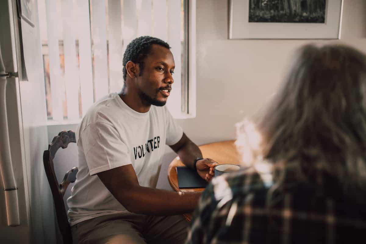 Two people having a thoughtful conversation in warm lighting illustrating social reflection and Cooley looking-glass self concept