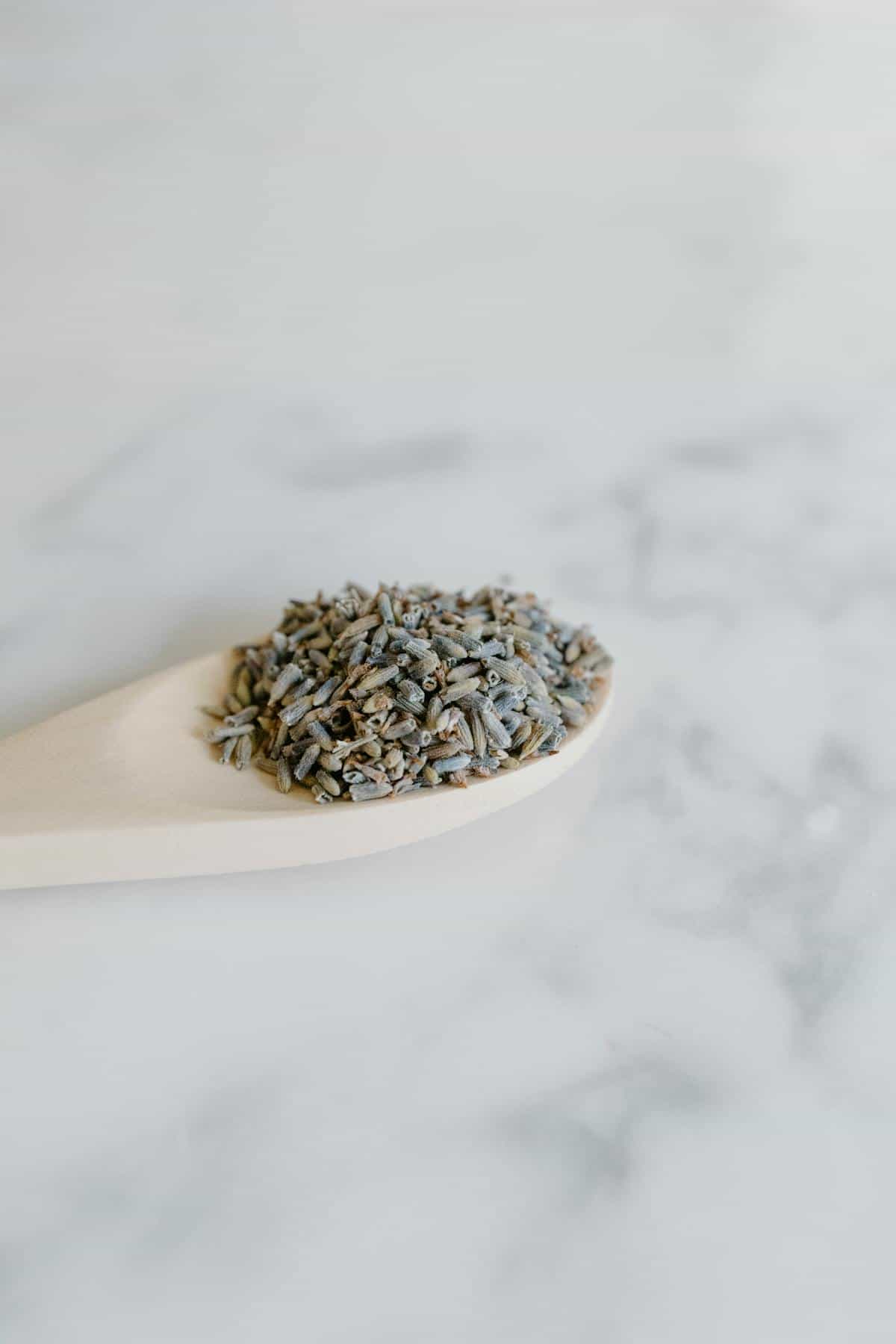 Fresh lavender sprigs and botanicals on neutral linen suggesting gentle home cleansing
