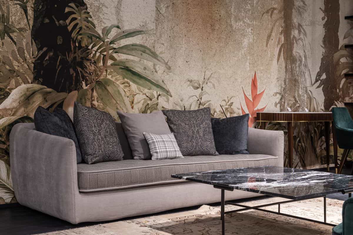 Sofa placed against a solid wall with cushions in a calm living room, illustrating feng shui sofa placement.