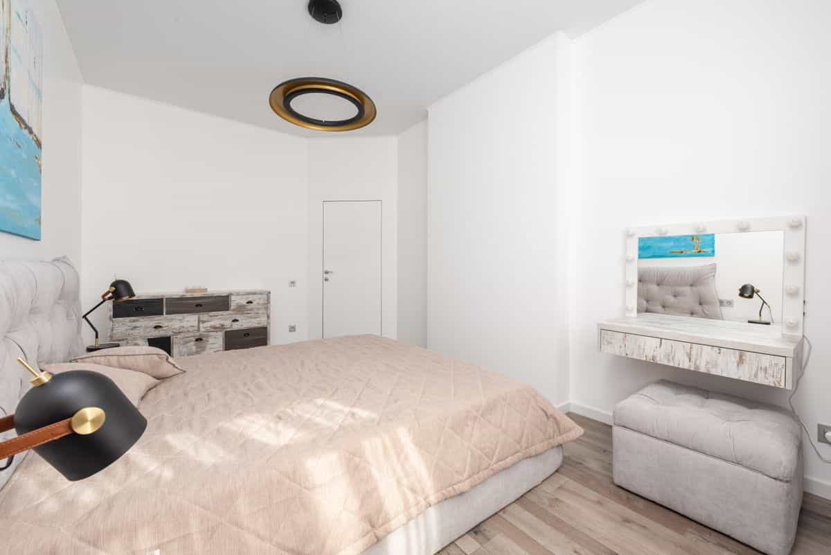 Cosmetic table and mirror near a bed illustrating where a dresser mirror should face Bedroom with a cosmetic table and mirror near the bed showing where a dresser mirror should face