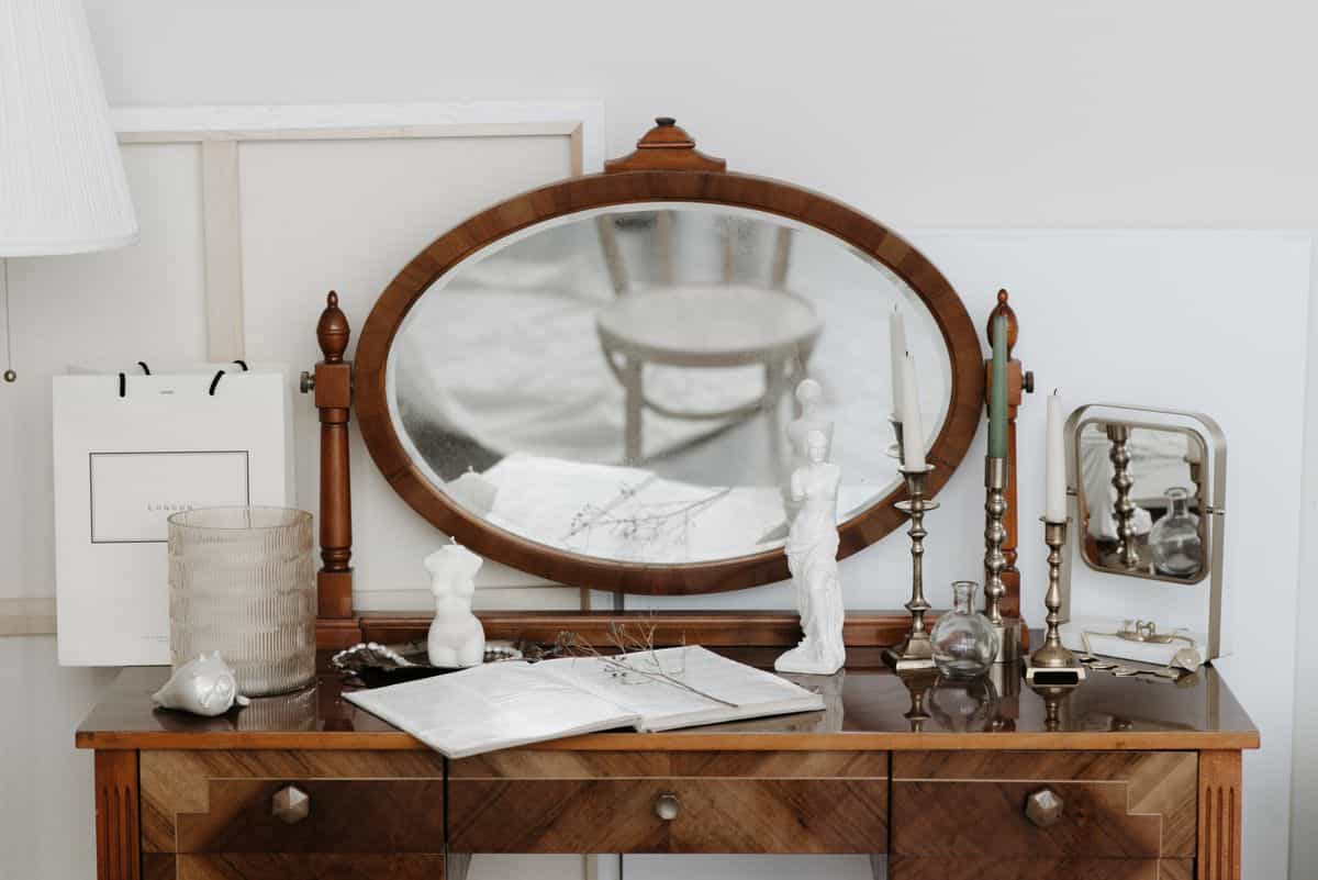 Antique dressing table with an ornate mirror illustrating a vintage dresser with mirror style Antique dressing table with an ornate mirror and candles showing a vintage dresser mirror style