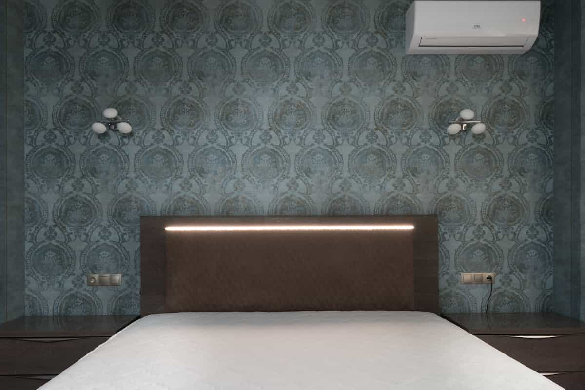 Bed with a solid headboard against a wall between two nightstands, illustrating the best bed position for feng shui.