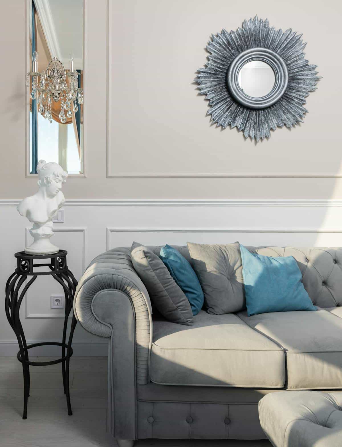Creative living room interior with decorative bust and round mirror above sofa illustrating feng shui mirror placement rules in a living area