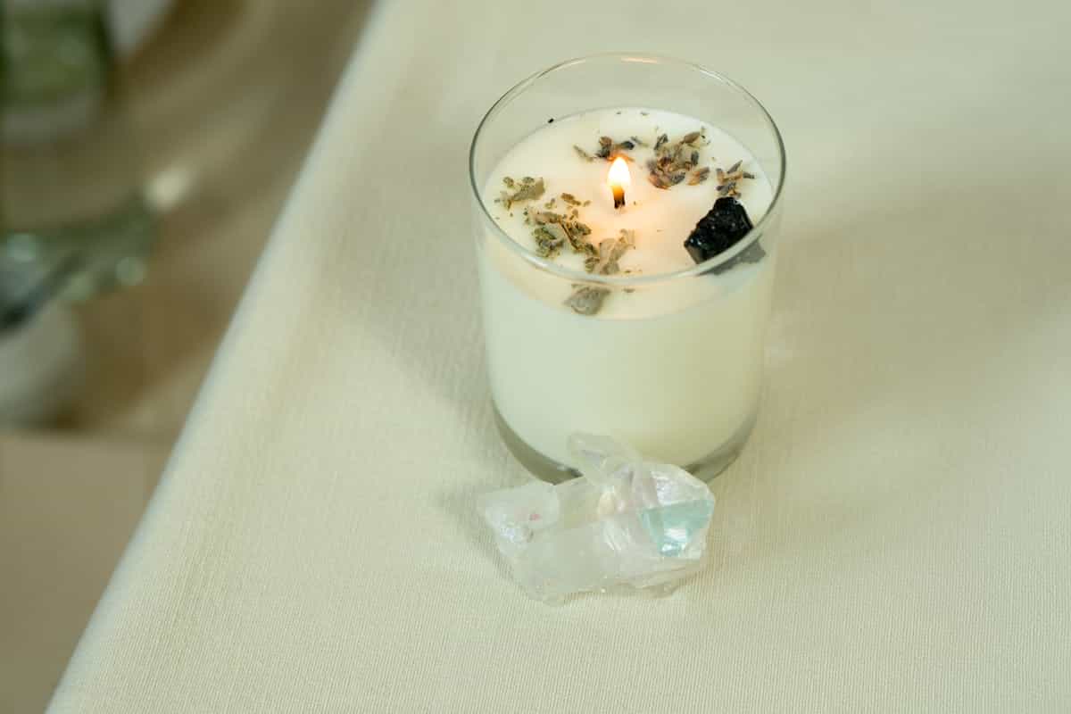 Soft candle aura with crystals conveying grounding ambience without pretending mirrors are portals