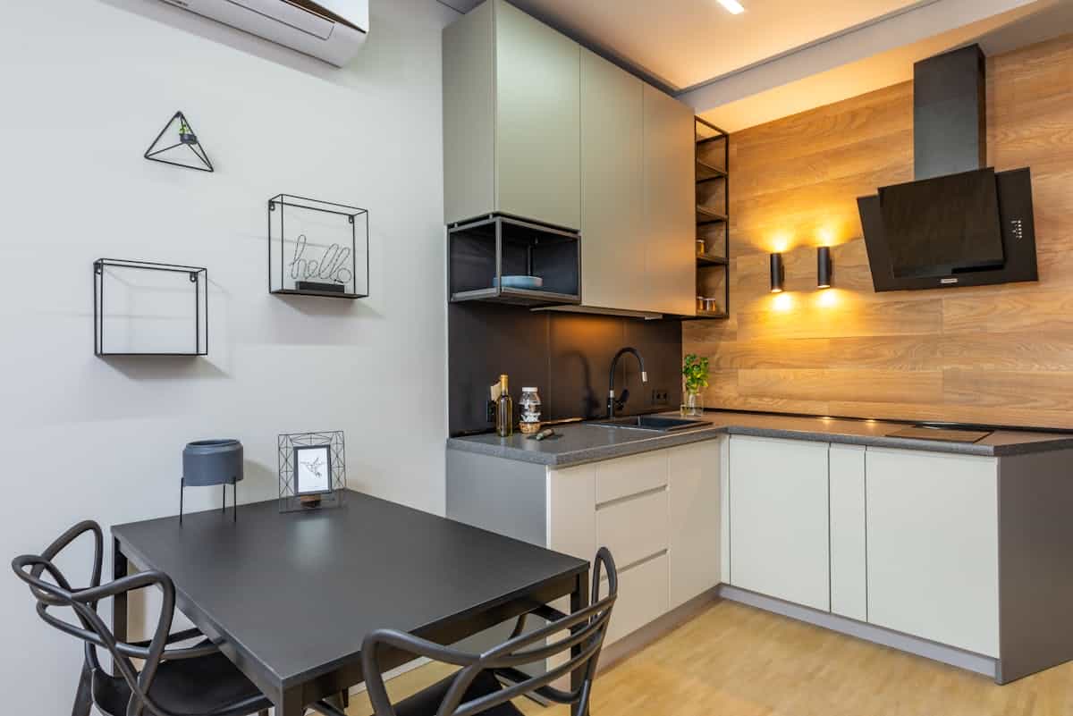 Modern kitchen with decorated wall illustrating why metal wall art suits a kitchen Modern kitchen with a decorated wall and appliances, illustrating why metal wall art suits a kitchen