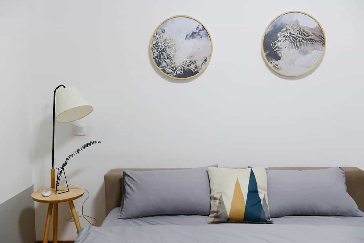 Bedroom focal wall above the bed illustrating where to start with bedroom wall decor Modern bedroom with minimalist abstract wall art above the bed, illustrating the focal wall in bedroom wall decor
