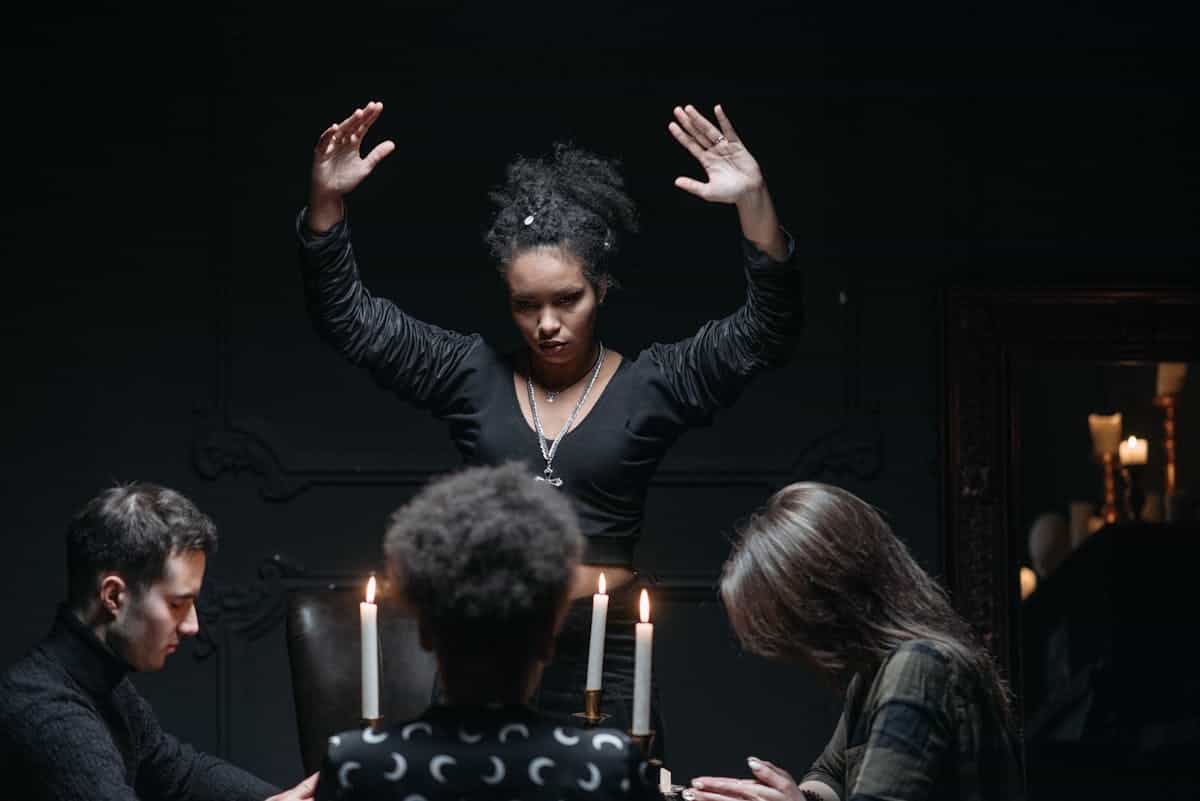 Spiritual seance gathering with participants around a candlelit table creating a mysterious and atmospheric scene