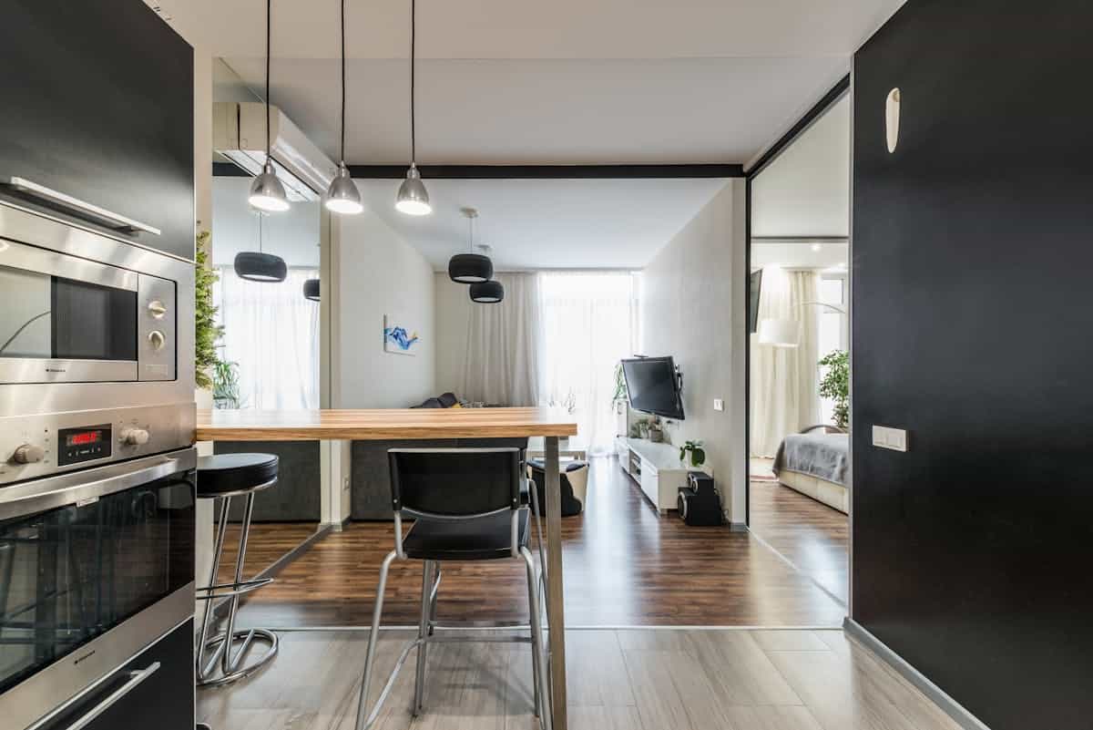 Studio apartment with a divided sleeping zone illustrating feng shui zoning of a small space Contemporary studio apartment with sliding doors separating the living and sleeping areas, illustrating feng shui zoning
