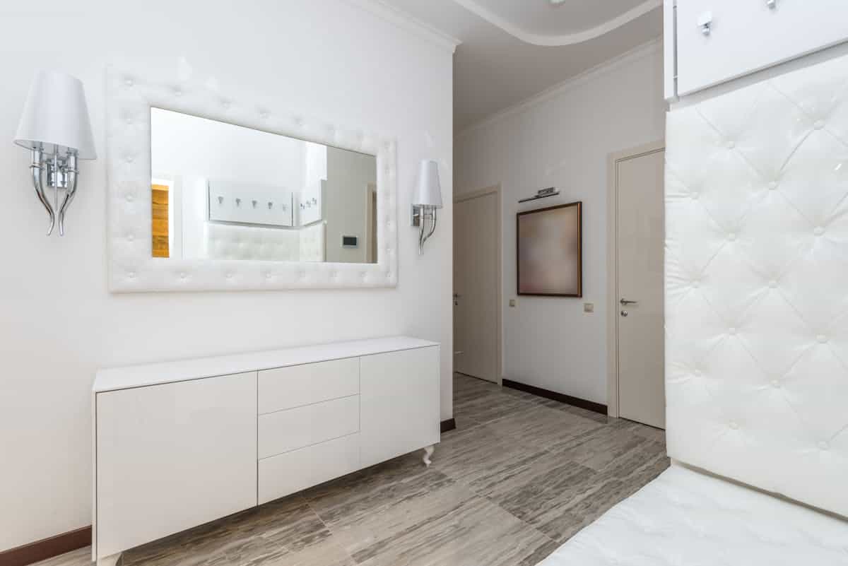 Large mirror hung on a bedroom wall at eye level, illustrating how high to hang a mirror in a bedroom.