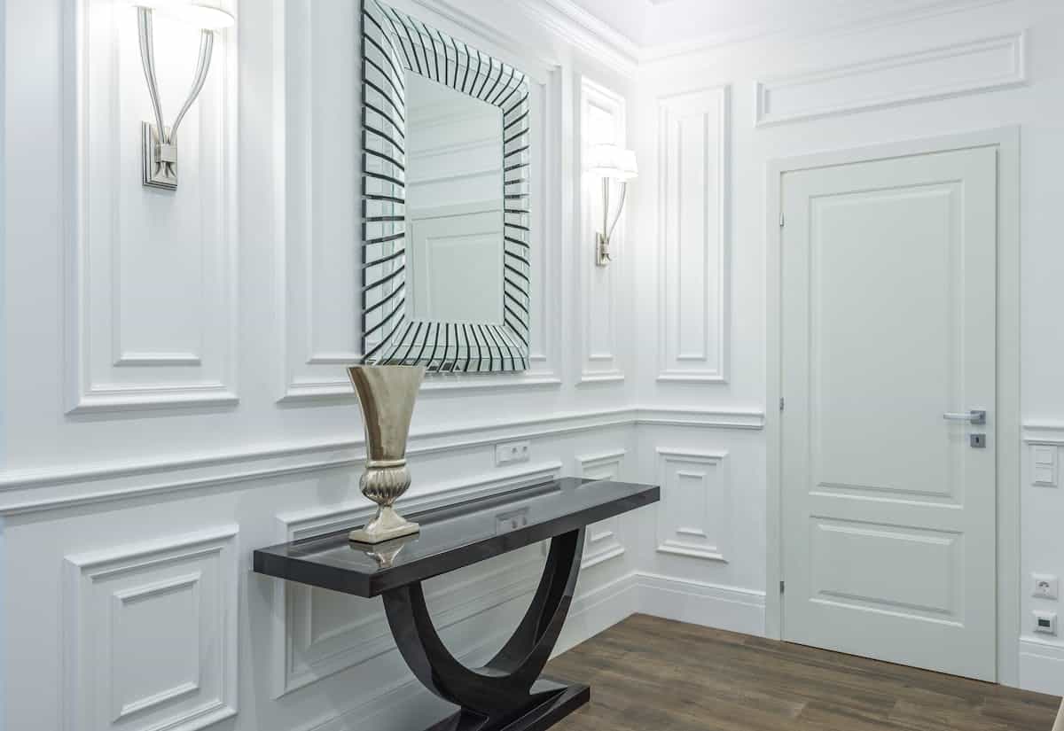 Sleek hallway mirror at eye level illustrating entryway mirror placement Sleek hallway with a mirror at eye level showing entryway mirror placement and height