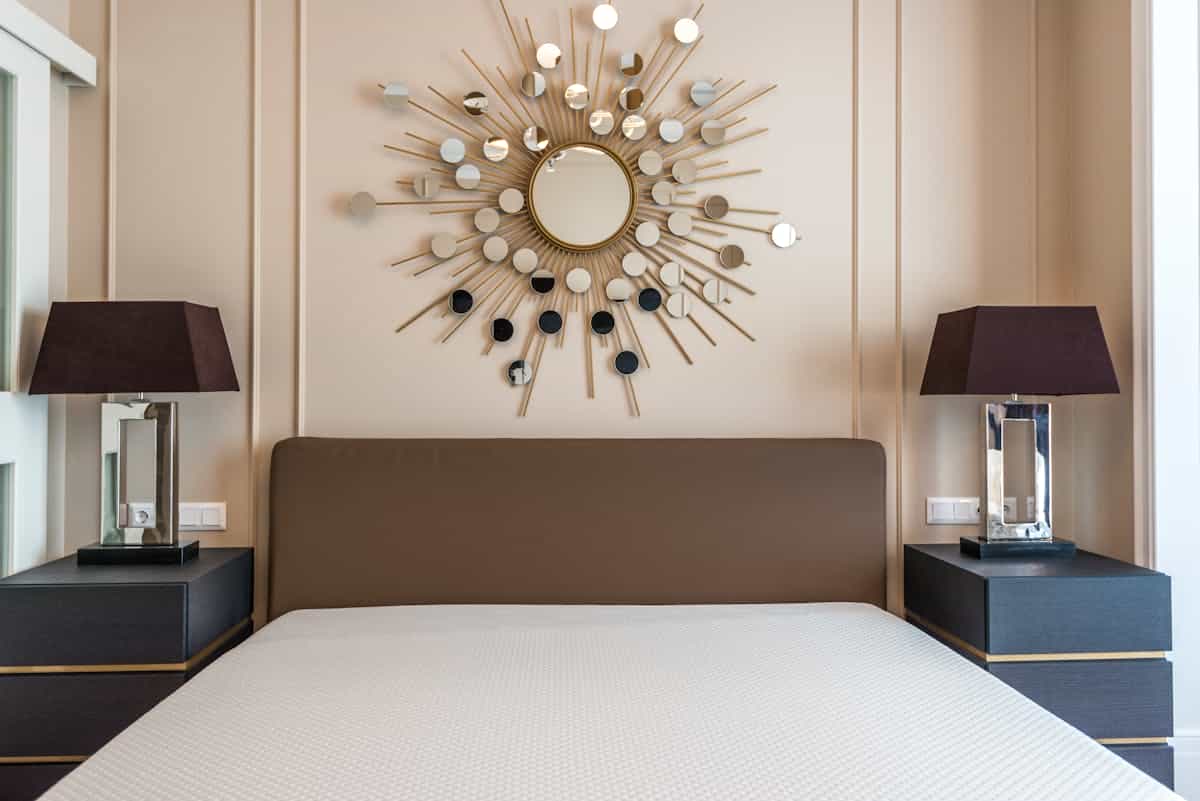 Bedroom with matching lamps on paired bedside tables illustrating the feng shui rule of balance and pairs Stylish bedroom with matching lamps on symmetrical bedside tables, illustrating the feng shui rule of pairs